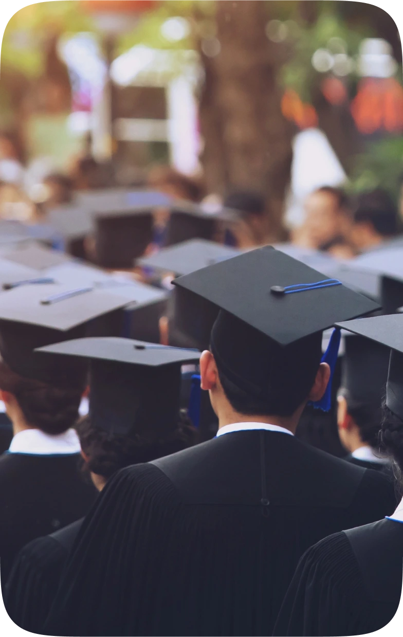 a number of students during their graduation wearing their graduation cap and robe.